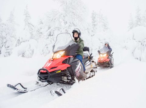 finnish lapland snowmobiling through snowy forest vf