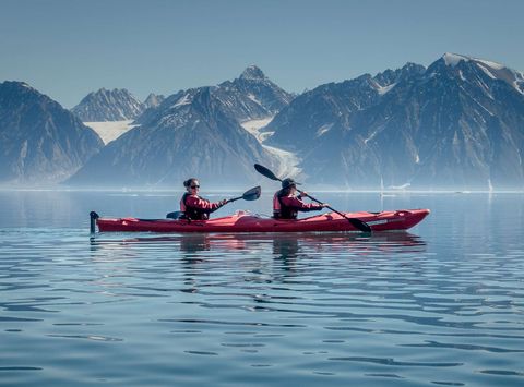 greenland kayking in calm waters on sunny day vg