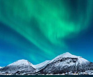 northern norway aurora over snow covered mountains gt