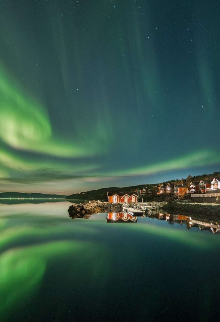 northern norway malangen resort aurora over fjord