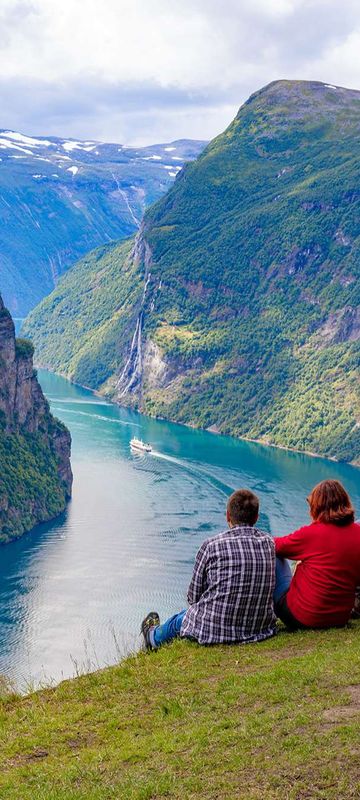 norway couples admiring geirangerfjord istk