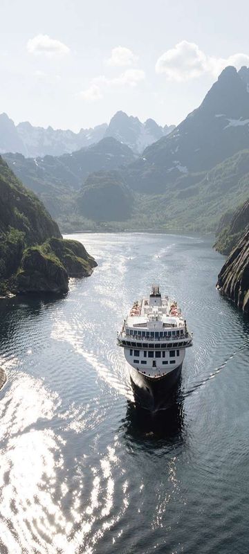 norway cruising through narrow fjord lofoten havila