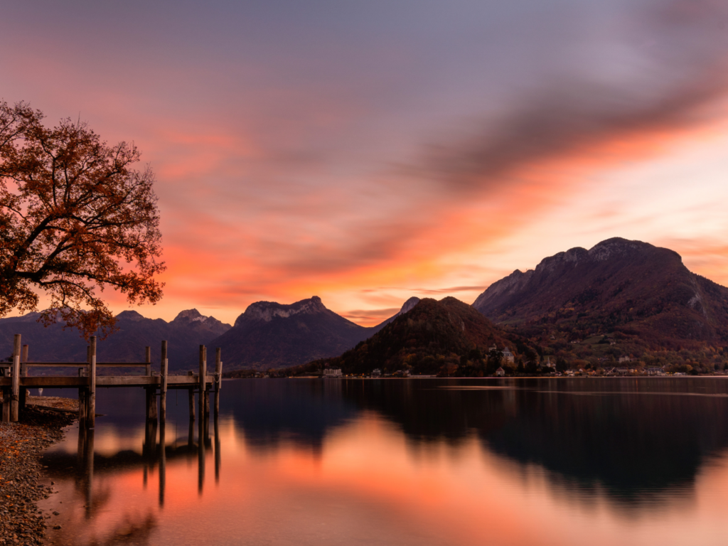 Picture of lake annecy at sunset with orange sky