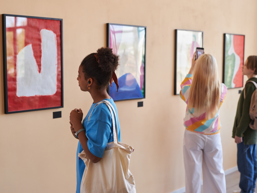 Picture of students looking at a picture in an art gallery